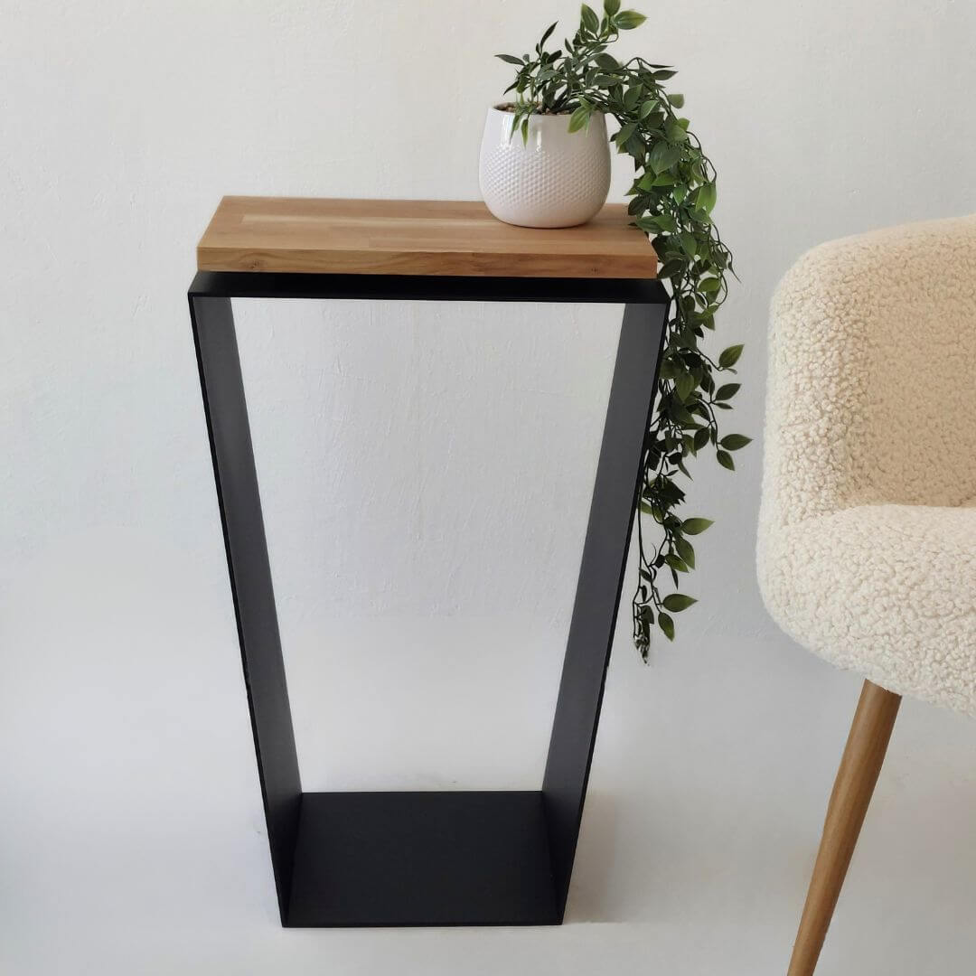 juodas modernus šoninis staliukas prie sofos svetainėje